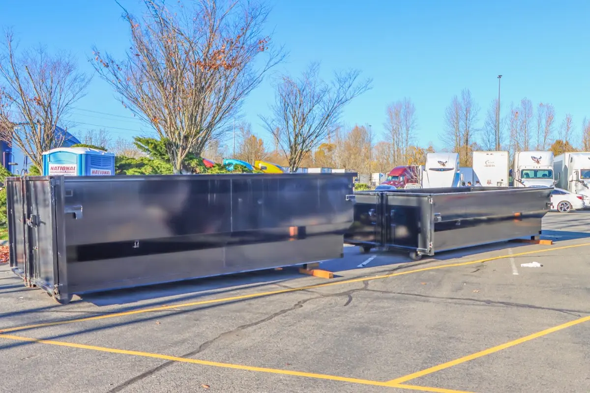 Professional dumpster rental service with roll-off container on residential driveway in New Smyrna Beach
